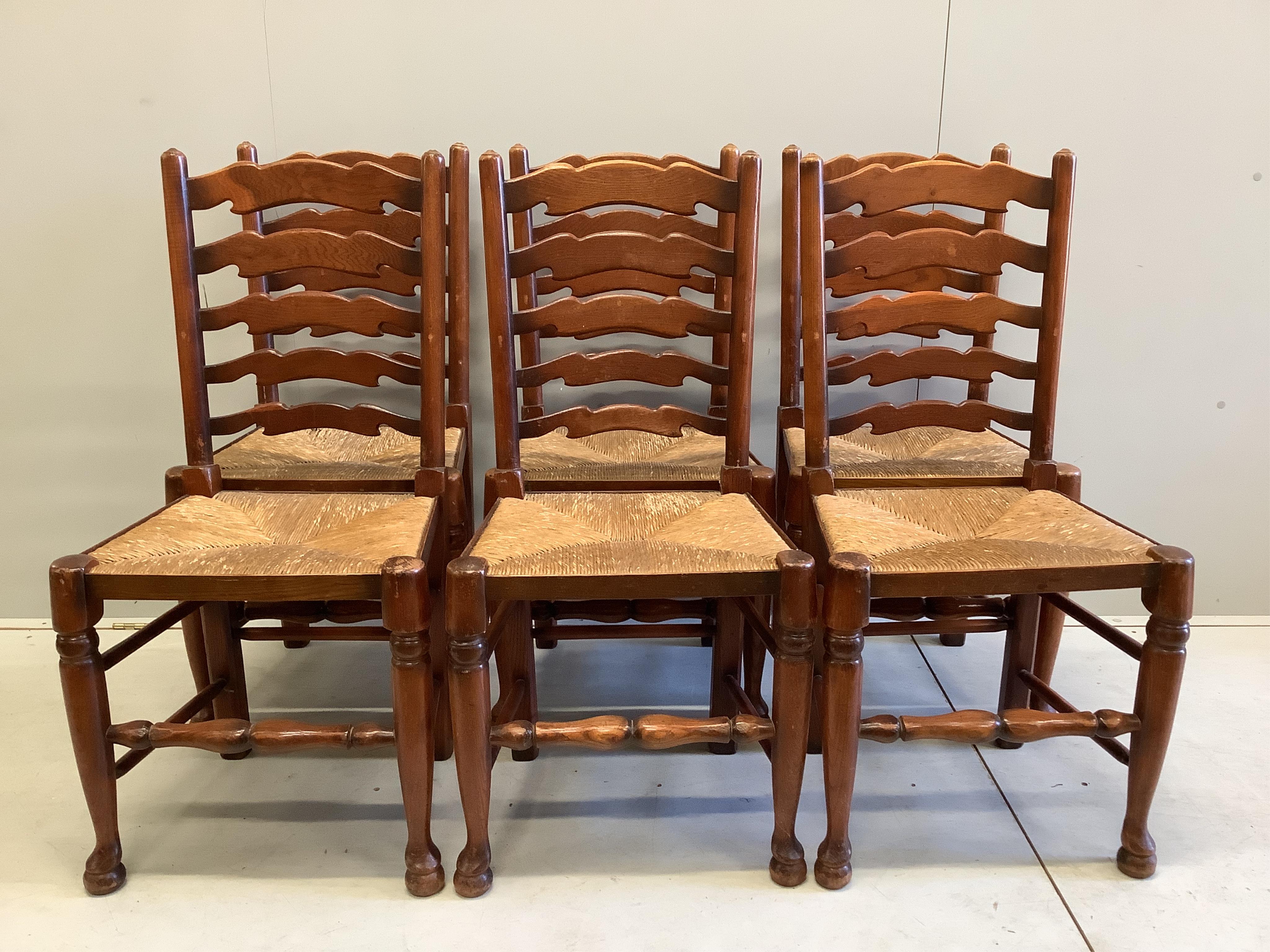 A 18th century style rectangular oak refectory dining table, width 183cm, depth 82cm, height 74cm and six rush seat ladderback chairs